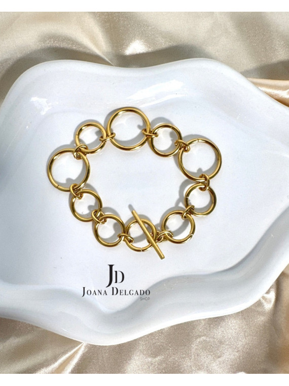 Pulsera dorada de acero inoxidable, perfecta para complementar.